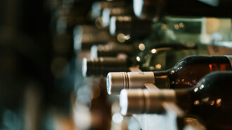 A collection of Tazzelenghe wine bottles neatly lined up, showcasing the wines from Friuli Venezia Giulia