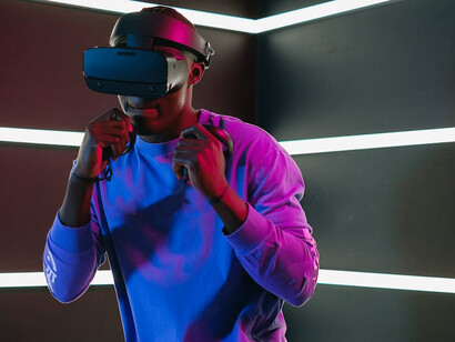 A person immersed in a virtual reality game via a VR headset