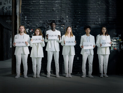Six people standing together with equality signs
