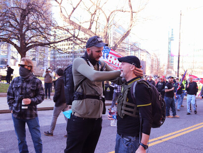 The Proud Boys, a right-wing extremist group in the United States, demonstrate their allegiance to Donald Trump, reflecting the persistent presence of far-right ideologies that continue to challenge democratic norms across the globe