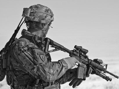 A soldier getting ready to aim his rifle, capturing the essence of global conflicts and shedding light on how shifting international power dynamics fuel wars and shape the ever-evolving global order