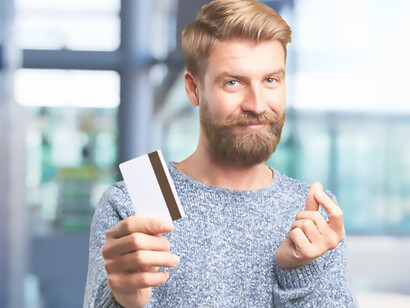 A gentleman clutches a diminutive credit card, embodying the essence of a shopping spree