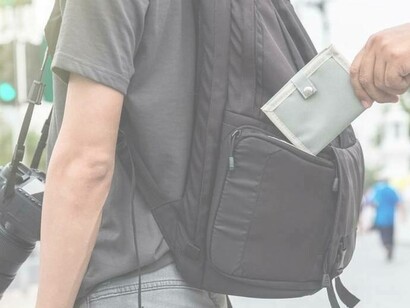 A waller being removed from a person's backpack by a pickpocketer in Paris, France