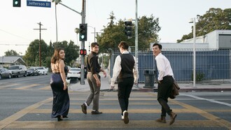Friends walking together along a walkable city street, capturing a realistic moment of everyday pedestrian life