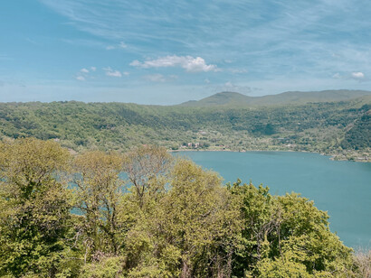 Small, grassy hills surround a blue lake