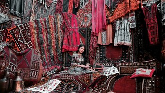 A woman sitting on traditional Turkish carpets in Cappadocia, Turkey—capturing the region’s rich cultural heritage and artisanal craftsmanship