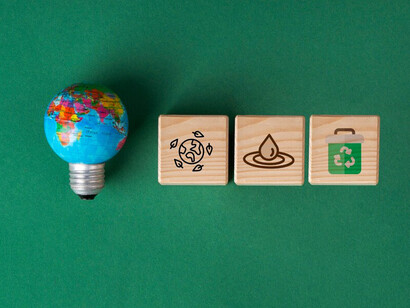 Sustainable development goals are illustrated on wooden cubes, symbolizing a commitment to environmental and social progress