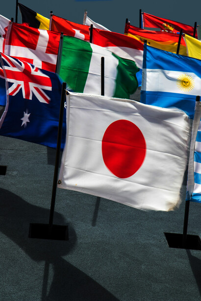 Colourful flags of different countries; global citizenship is a mindset and a way of moving through the world with eyes wide open and arms stretched wide