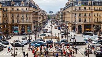A vibrant European city centre with citizens going about their day, representing the meeting point of public policy, work, and social inclusion
