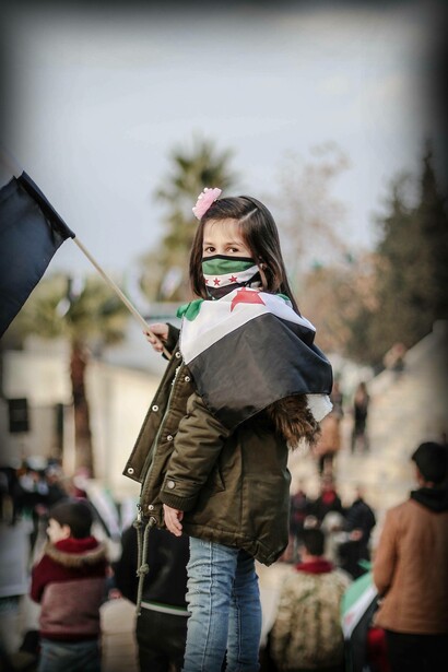 Young girl with Syrian flag in Idlib, Idlib Governorate, Syria