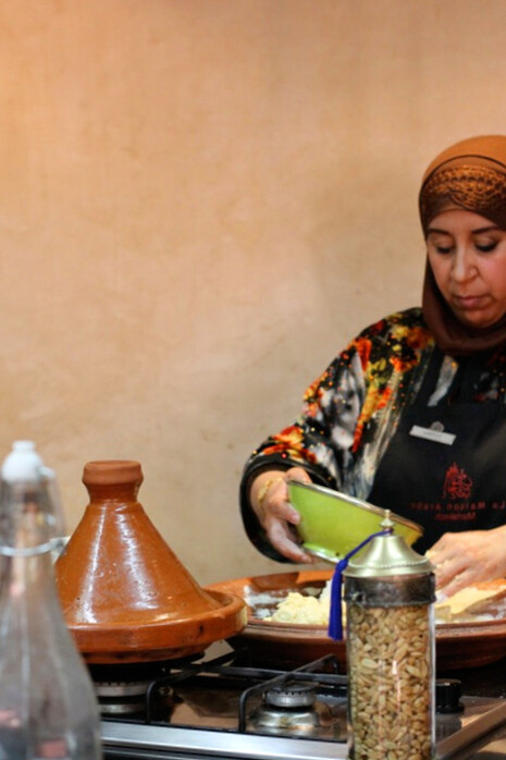 In the heart of the kitchen, a skilled hand shapes msemen, the delicate layer of Moroccan cuisine that perfectly complements the rich, spiced Rfissa