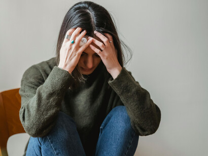 A stressed young woman sitting on a chair