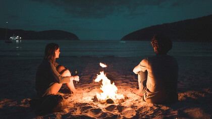 Couple chilling at the bonfire in Tasmania, Australia