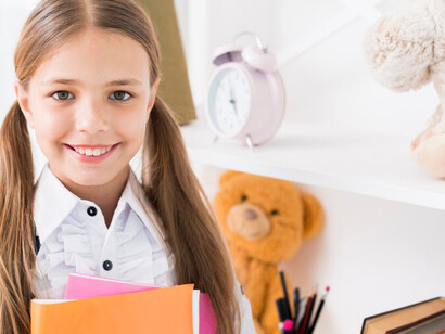 Schoolgirl writing in a notebook with a pencil, promoting girls' education, school life, and empowering young women