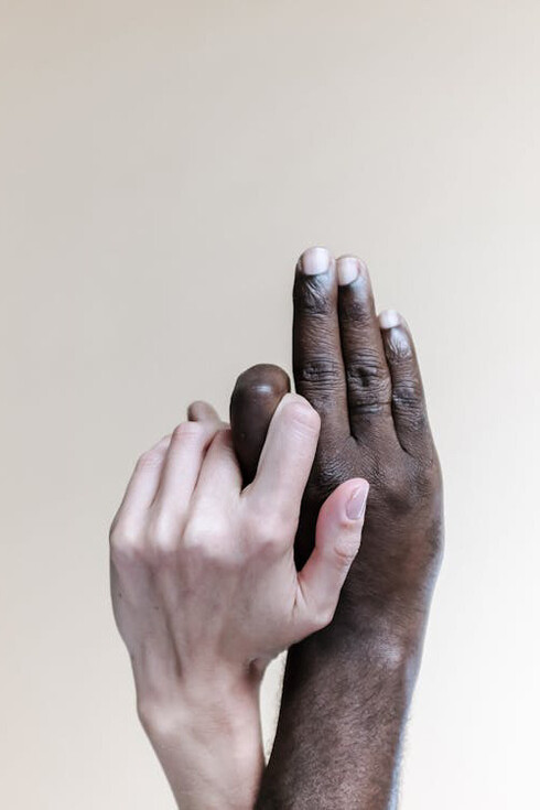 Hands of different cultures intertwine, symbolizing the unity of humanity beyond individual plans, embracing the essence of universal values in cultural acceptance