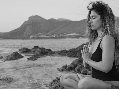 A woman sits near the water, the law of disintegration and the biological being