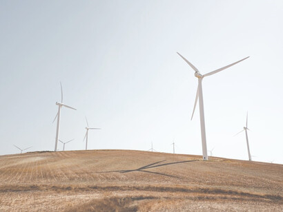 White windmills on brown field during daytime