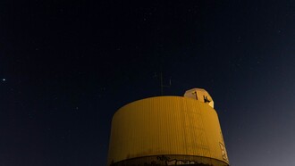 A lone observation setup under the night sky captures the quiet, methodical search for unidentified aerial phenomena