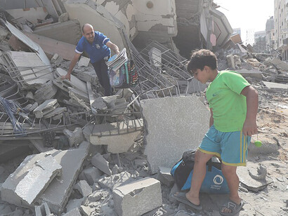 On October 8, 2023, Palestinians inspect the rubble of Aklouk Tower in Gaza City, destroyed by Israeli airstrikes