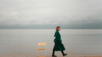 A person walking alone along the seashore