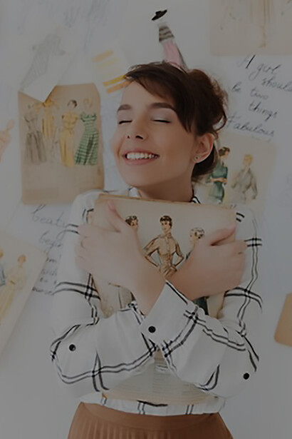 The epitome of creativity as a talented young fashion designer poses with her sketchbook, exuding innovation and flair in her craft