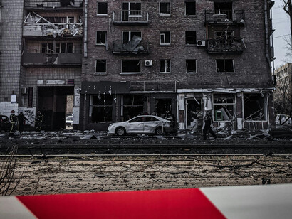 A view of the lower levels of a building and the street, both destroyed by war