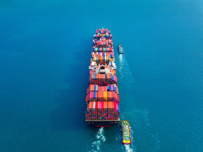 A ship carrying containers over the ocean