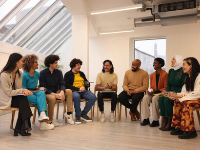 A group of individuals engaged in deep philosophical debates, sitting side by side, reflecting on science and spirituality