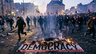 A banner of democracy burning in midst a protest, symbolising a crisis of confidence in elected leadership