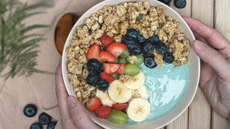 A fruit bowl with spirulina powder, a nutrient-rich supplement made from blue-green algae