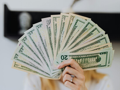 A set a US dollar bills held out as they were a fan