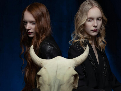 Two women staring at a cow's skull