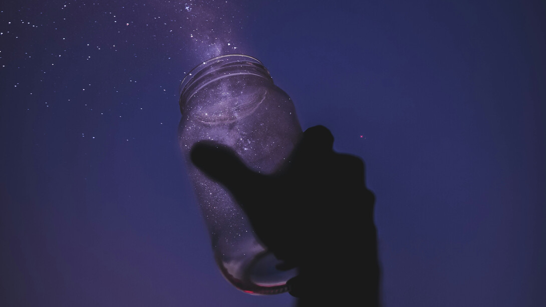 A person releasing stardust onto the night sky
