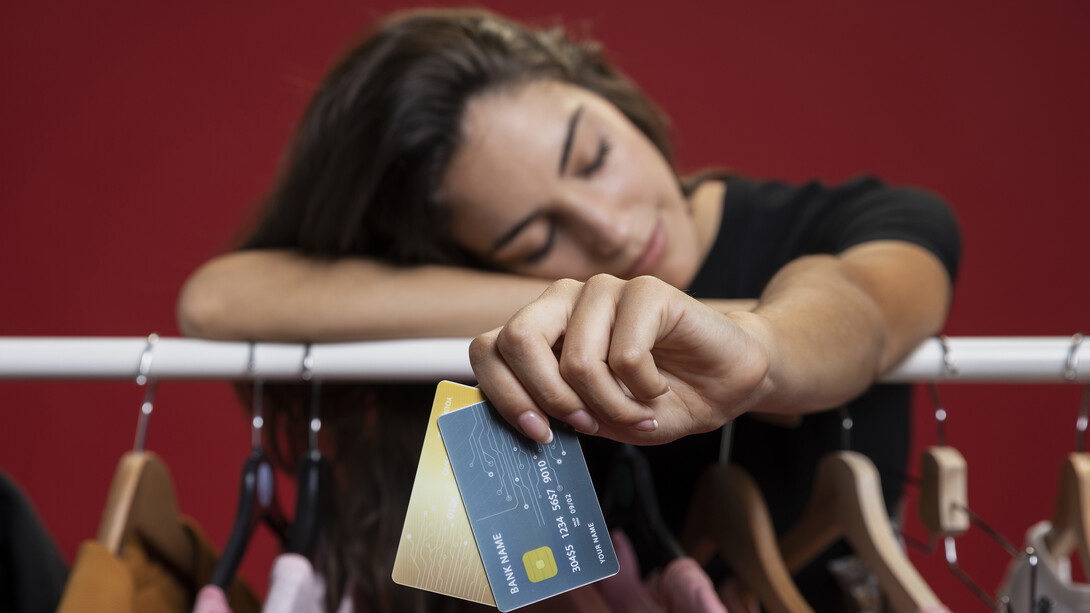A woman after shopping, holding credit cards