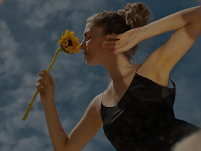 A woman elegantly poses with a round mirror and flower, symbolizing self-reflection, personal growth, and inner peace