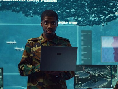 A diverse group of military officers leveraging advanced holographic technology to analyze real-time data, enhancing military strategy in an era of techno-fascism