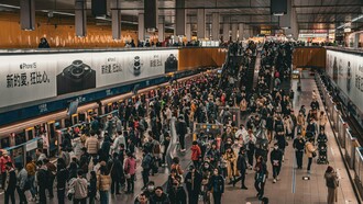 Thousands of passengers moving through a crowded transit hub, symbolizing the scale of modern urban life and the importance of accessible public transportation