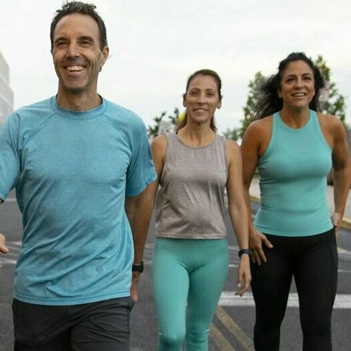 A lively group of people, dressed in colorful workout attire highlights the significance of forming consistent training habits, staying motivated, and thinking creatively to fit exercise into even the busiest schedules, ensuring physical activity remains a fun and integral part of life