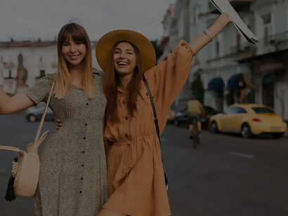 Chic young women exploring Europe in fashionable spring attire, epitomizing trendy travel experiences