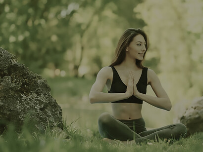 In the serenity of nature as a woman practices yoga in the forest