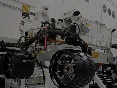 Wheels Installed On Curiosity. Originally taken in July 2010, this photo shows NASA engineers installing six wheels on the Curiosity rover