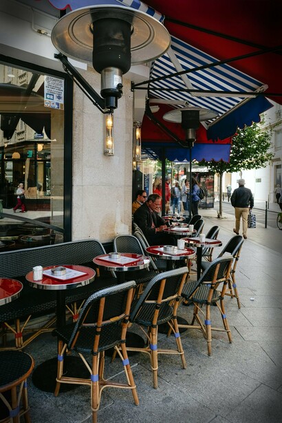 People sitting outside a cafe in Paris, France