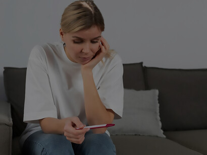 An evocative image captures the emotional struggle of a woman facing infertility, holding a negative pregnancy test
