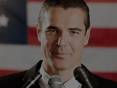 US politician with microphones held by journalists