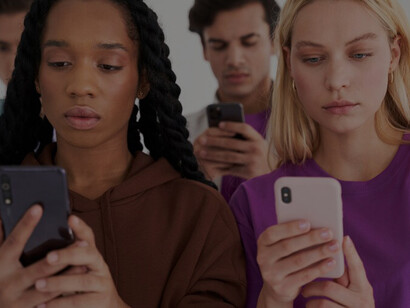 A group of individuals engrossed in their cell phones, absorbed in reading and gathering information