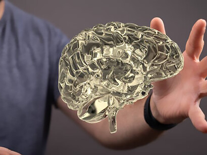 A captivating close-up reveals the intricate details of a 3D-rendered brain, while alongside it, a man delicately extends his hand, making tactile connection with the neural imagery