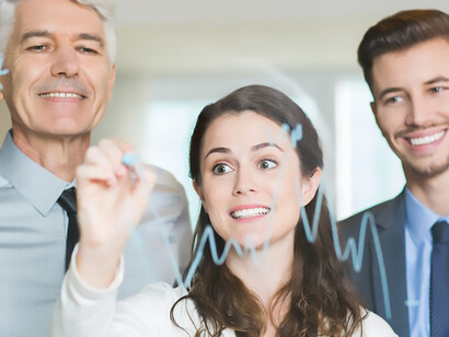 Focused businesswoman shares graph insights with colleagues, fostering collaborative analysis and decision-making in the workplace