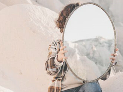 As the man gazed across the barren desert, his mirror in hand, he contemplated the profound interconnectedness of different levels or aspects of reality.