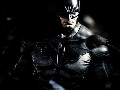 A depiction of the Dark Knight superhero, Batman, looking menacing and ready to deliver justice