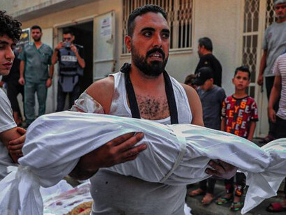 A grieving father carries his child, a heartbreaking casualty of the 2023 Gaza conflict